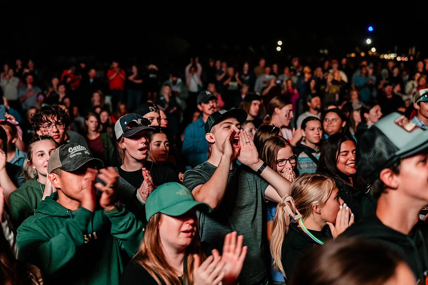 Students worshipping together in the crowd