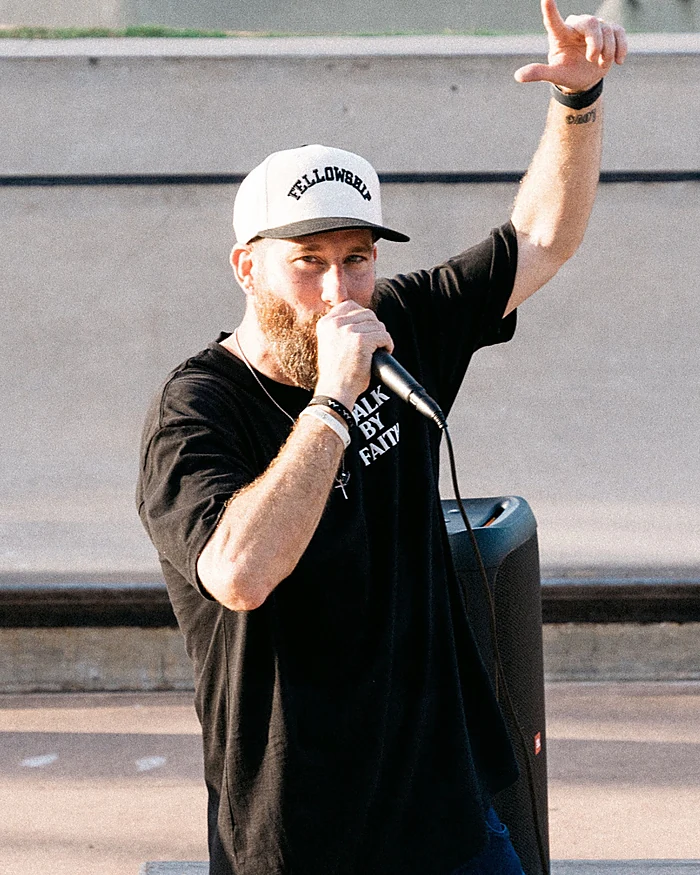 Kenny Hampton speaking into a microphone at the skatepark
