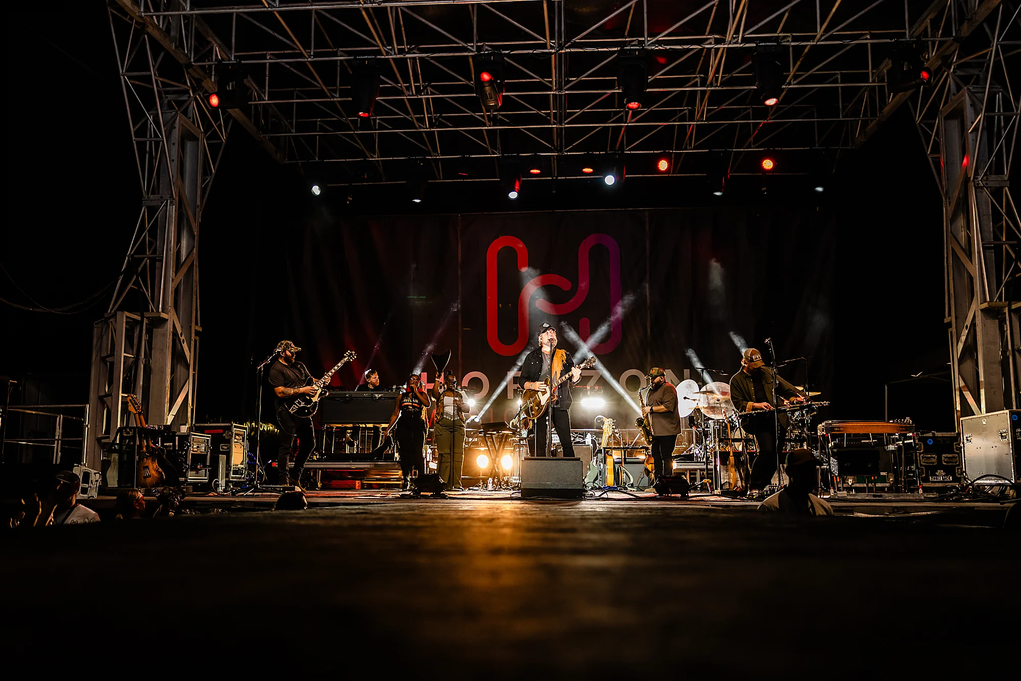 The Horizon stage lit up at night with the band performing