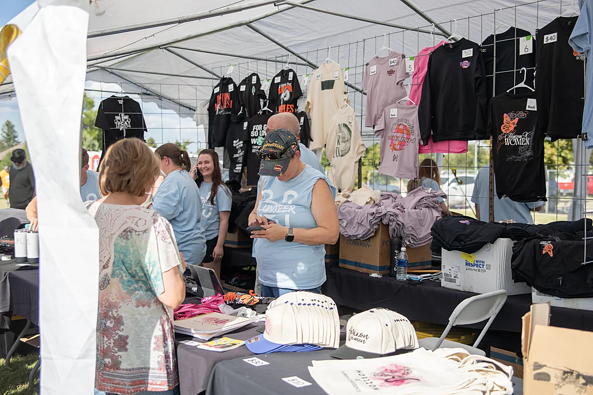 Volunteers working the merch tent at Horizon 2026