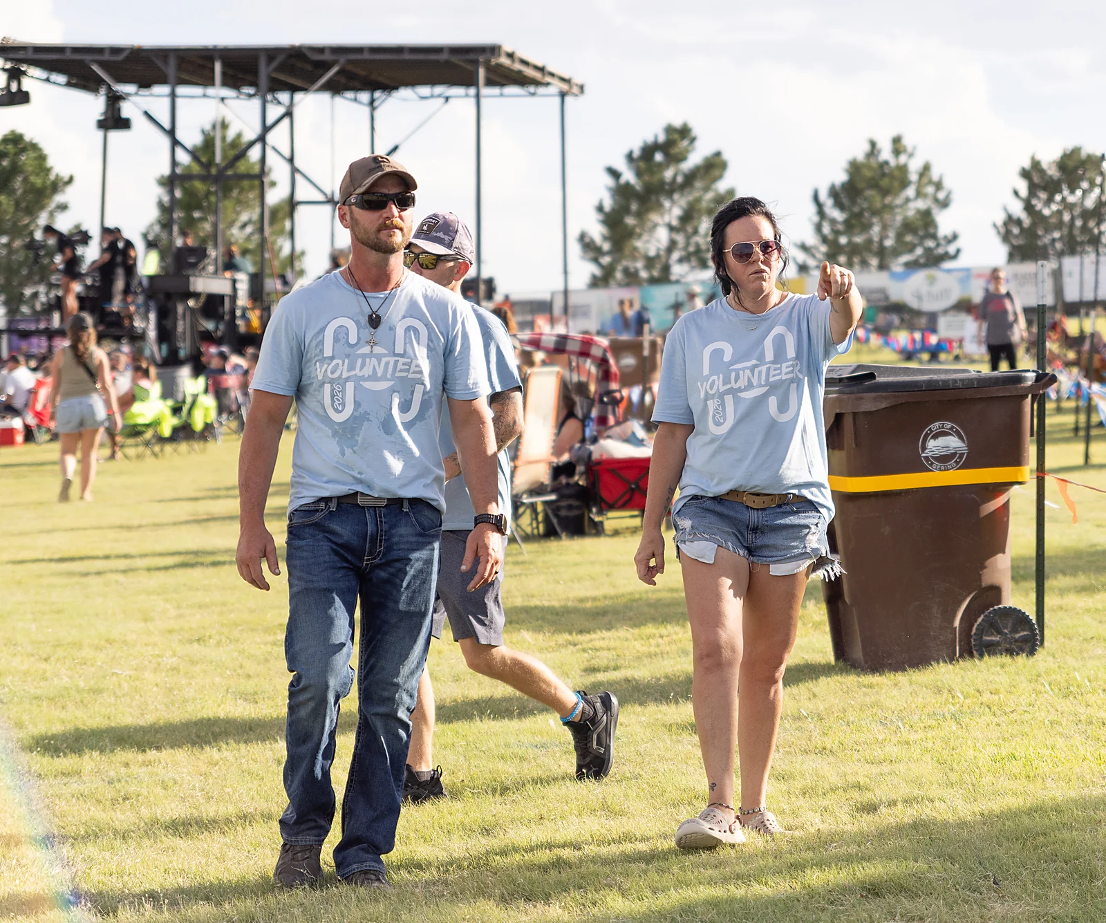 Volunteers in light blue shirts walking the festival grounds at Horizon 2026